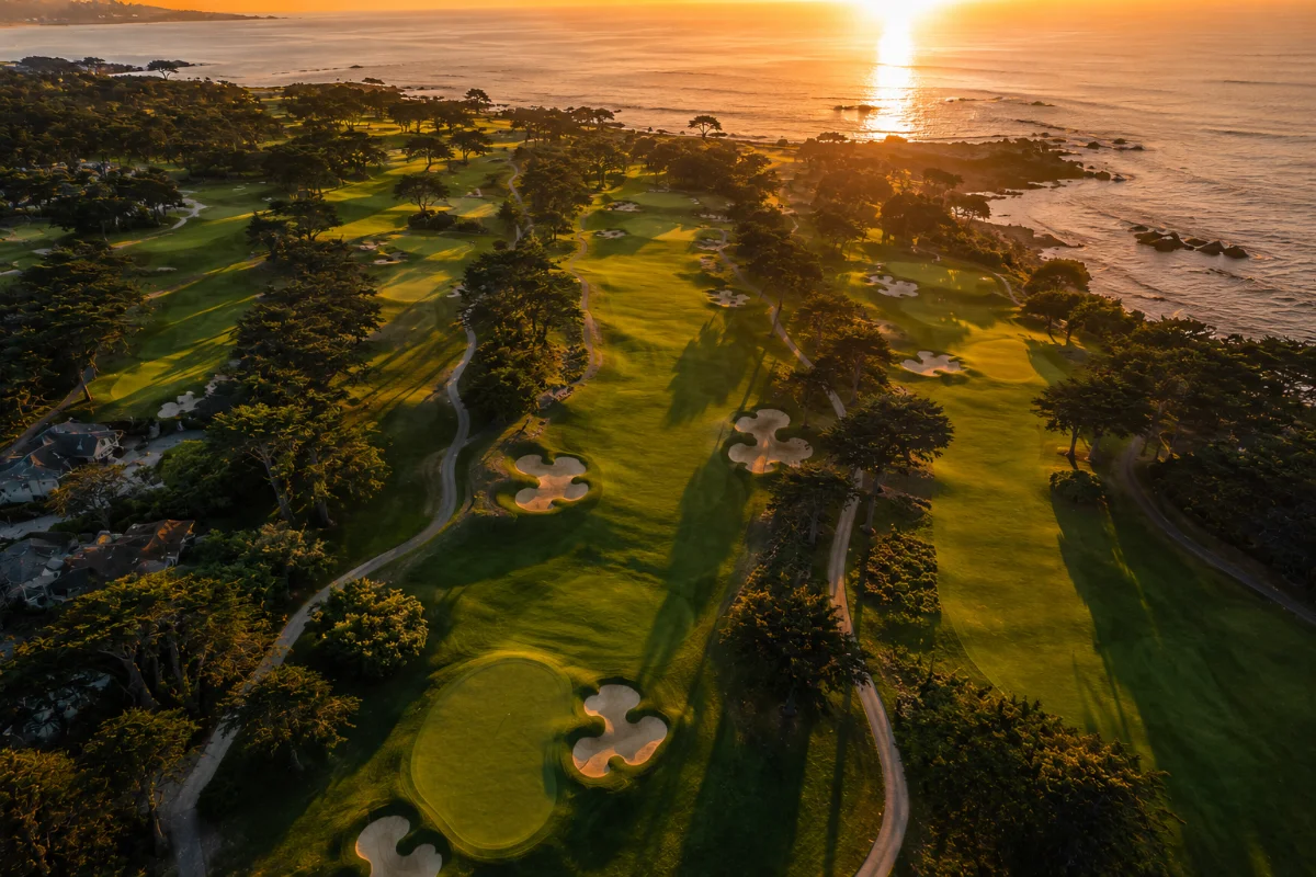 Aerial view of a seaside golf course at sunset